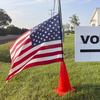 An American flag waves in the breeze next to a sign directing Ohioans to vote inside Tharp Sixth Grade School, Tuesday, Aug. 8, 2023 in Hilliard, Ohio.