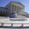 People stand on the steps of the U.S. Supreme Court, Feb.11, 2022, in Washington. 