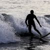 A person surfs, Saturday, Oct. 22, 2022, in the Far Rockaway neighborhood of the Queens borough of New York. 