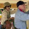 Former US President Jimmy Carter and former First Lady Rosalyn Carter attach siding to the front of a Habitat for Humanity home being built June 10, 2003 in LaGrange, Georgi