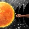 A hand extending a finger in space, reaching out to touch the Sun.