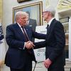 U.S. President Donald Trump (L) shakes hands with Apple CEO Tim Cook during an event in the Oval Office of the White House on August 6, 2025 in Washington, DC. 