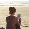 reading a Kindle on the beach