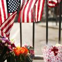  Flowers are left at a security gate near the scene of yesterday's bombing attack at the Boston Marathon on April 16, 2013 in Boston, Massachusetts. 