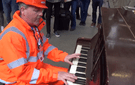 A traffic marshal in London's St Pancras Station surprises travelers with a quick turn on a public piano.