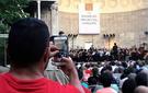 An audience member snaps a photo of The Knights at the Naumburg Bandshell.