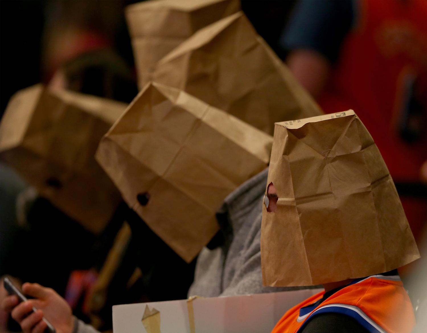 Five fans wear paper bags on their heads in the 4th quarter when the New  York Knicks play the Houston Rockets at Madison Square Garden in New York  City on January 8
