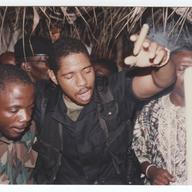 Chucky with Benjamin Yeaten at the funeral for a colleague at an unknown location in Liberia. 