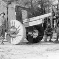 Soldiers in the 603rd assembling an improvised wooden dummy.
