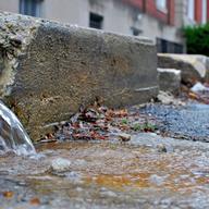 Storm water flowing onto a street 