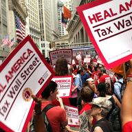 Members of the nurses union, National Nurses United, and other workers converge on Wall Street to protest against financial intuitions and inequality on June 22, 2011 in New York City.