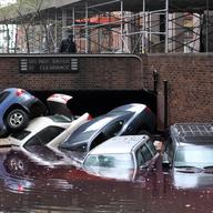 Cars piled on top of each other at the entrance to a garage on South Willliam Street in Lower Manhattan October 31, 2012 in New York as the city begins to clean up after Hurricane Sandy.