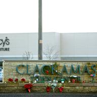 Flowers and candles sit outside the Clackamas Town Center mall on December 13, 2012 in Clackamas, Oregon.