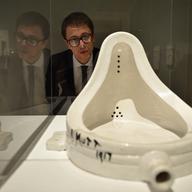 A gallery assistant views 'Fountain Marcel Duchamp' at The Scottish National Gallery of Modern Art on December 14, 2012 in Edinburgh, Scotland.