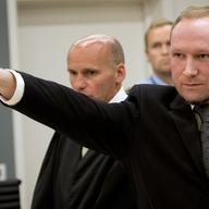 August 24, 2012 Self confessed mass murderer Anders Behring Breivik raising his fist in a right wing salute after being sentenced to 21 years in prison, in court room 250 at Oslo District Court.