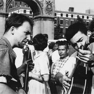 Banjo player and guitar player, with crowds and Washington Square Arch in the background, Washington Square Park, New York, New York, August 26, 1962