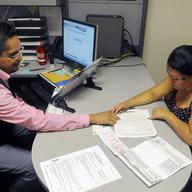  Enrollment Specialist Horacio Castaneda, left, helps Rosa Ayala Cruz, right, apply for health benefits at the Denver Health Westside Family Health Center on October 01, 2013 in Denver, Colorado. 