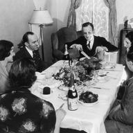 A family sits down to Thanksgiving dinner, circa 1935.