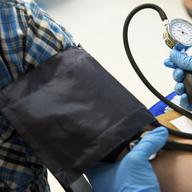 A man gets his blood pressure checked at a community health fair in the Bronx geared to build health knowledge among Bronxiteshealth, St Barnabas, healthcare, blood pressure, fair, Bronx, Rx in the Bx