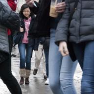 A crowd of high school students laugh as they walk to school on a Monday morning in Lower Manhattan.