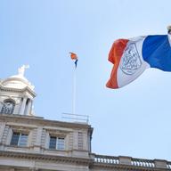 The New York City flag flies outside New York City Hall. 