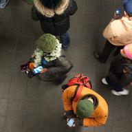 Commuters use their smartphones in the Times Square station.