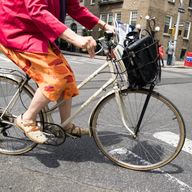  A woman rides her bike by Washington Park in lower Manhattan on a sunny April day.  