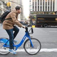 A man commutes by Citi Bike during the evening commute on 7th Ave in midtown.
