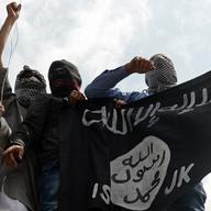 Kashmiri demonstrators hold up a flag of the Islamic State of Iraq and the Levant (ISIL) during a demonstration against Israeli military operations in Gaza, in downtown Srinagar on July 18, 2014. 
