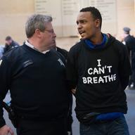 A demonstrator is arrested after a small group marched and chanted through a shopping mall during a protest against police abuse on December 13, 2014 in Chicago, Illinois. 