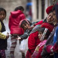 An indigenous Peruvian girl begs for money in traditional dress in the Incan city of Cusco, on January 15, 2014 in Cusco, Peru. 