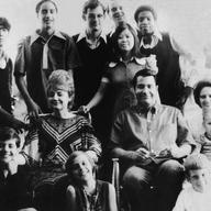 Portrait of American religious leader Jim Jones (1931 - 1978), the founder of the People's Temple, and his wife, Marceline Jones (1927 - 1978), seated in front of their adopted children.