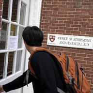 Freshman Winston Yan enters the Admissions Building at Harvard University September 12, 2006 in Cambridge, Massachusetts. 