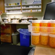 Pharmacist Hank Wedemeyer fills prescriptions as generic diabetes medicine awaits distribution at a community health center for low-income patients on December 1, 2009 in Aurora, Colorado.