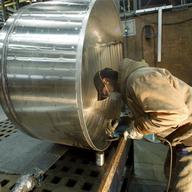 In this Dec. 14, 2011 photo, Chris Keltz polishes a tank JV Northwest, in Canby, Ore. JV Northwest manufactures stainless steel vessels.