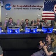 In this photo provided by NASA, Juno team members celebrate in mission control of the Space Flight Operations Facility at the Jet Propulsion Laboratory after receiving confirmation from the spacecraft