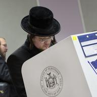 Voters mark their ballots, Tuesday, Nov. 8, 2016, in the Boro Park neighborhood in the Brooklyn borough of New York. The neighborhood has a diverse population, including many orthodox Jews.