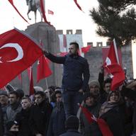 People wave national flags as they protest after a car bomb attack in central Anatolian city of Kayseri, Turkey, late Saturday, Dec. 17, 2016. More than a dozen Turkish troops were killed.