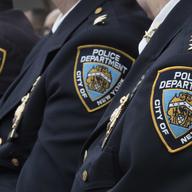 Police brass listens as New York City Mayor Bill de Blasio, and NYPD Commissioner Jim O'Neil conduct a news conference, Jan. 4, 2017, in New York. NYC recorded its fewest number of shootings last year