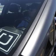  In this July 15, 2015, file photo, Uber driver Karim Amrani sits in his car parked near the San Francisco International Airport parking area in San Francisco. 