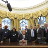 President Donald Trump poses with union leaders in the Oval Office at the White House in Washington, Monday, Jan. 23, 2017.