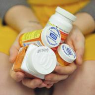 Heidi Wyandt, 27, holds a handful of her medication bottles at the Altoona Center for Clinical Research in Altoona, Pa., on Wednesday, March 29, 2017.