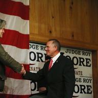 Steve Bannon, left, introduces U.S. senatorial candidate Roy Moore, right, during a campaign rally, Tuesday, Dec. 5, 2017, in Fairhope, Ala.