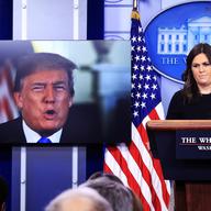 President Donald Trump speaks via a video monitor to journalists in the press briefing at the White House during the daily press briefing with press secretary Sarah Huckabee Sanders.