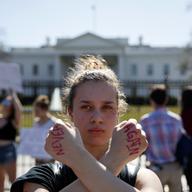 Gwendolyn Frantz, 17, of Kensington, Md., stands in front of the White House during a student protest for gun control.