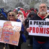 Debbie Burke, left, an elementary school teacher in Pike County, and her husband Gary Burke rally against a proposed pension overhaul bill, in Frankfort, Ky. on Wednesday, March 21, 2018.