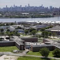  In this this June 20, 2014, file photo, the Rikers Island jail complex stands in the foreground with the New York skyline in the background. 