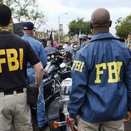 FBI agents look on as the gay pride parade kicks off in West Hollywood, Calif., on June 12, 2016.