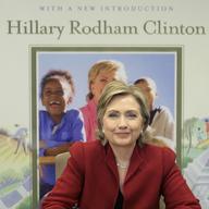 In this Dec. 18, 2006 file photo, Sen. Hillary Rodham Clinton signs copies of the 10th Anniversary edition of her book 'It Takes a Village' in New York.