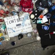 A memorial for Eric Garner rests on the pavement near the site of his death, Saturday, July 19, 2014, in the Staten Island borough of New York.